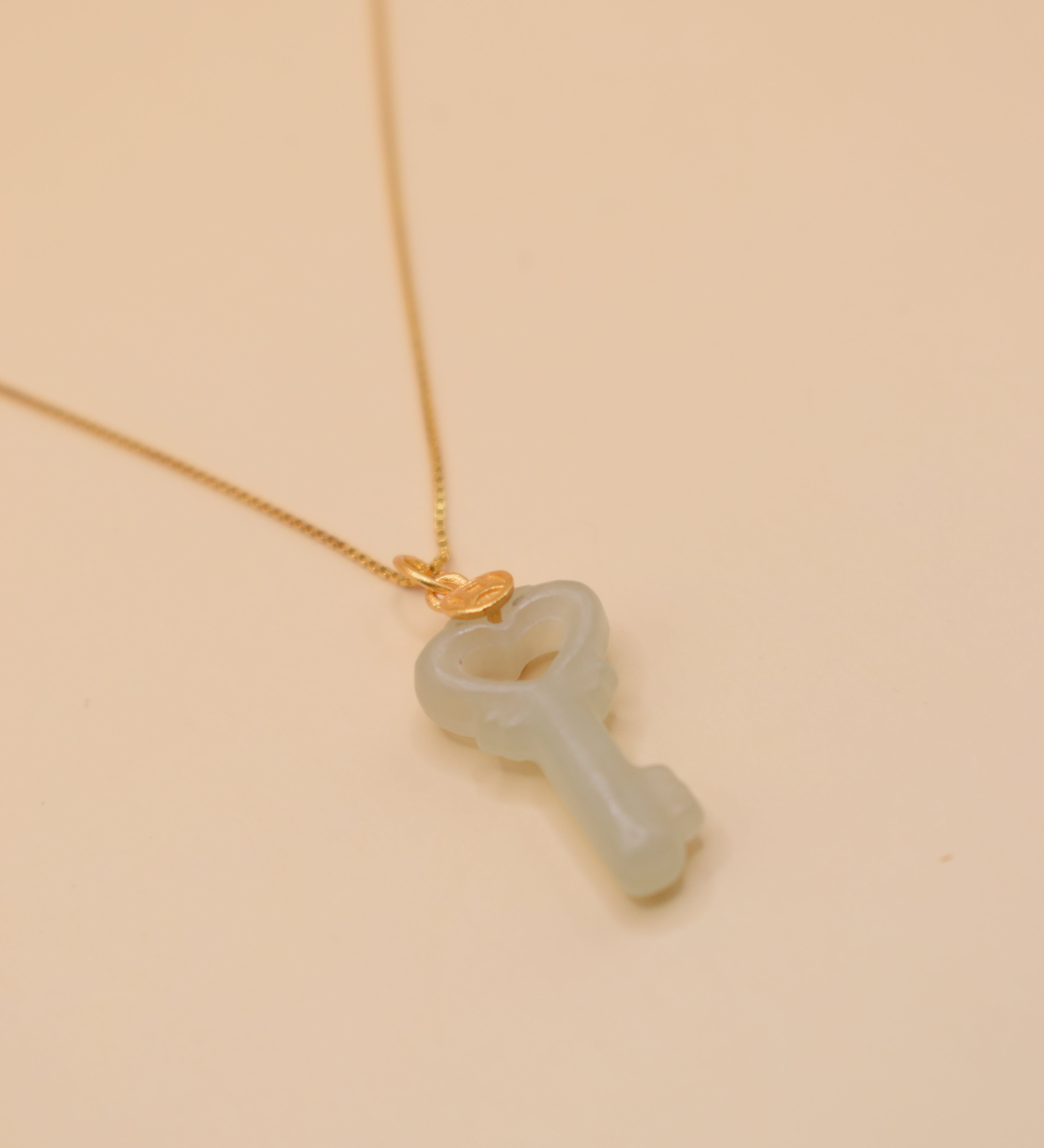 Gold key pendant necklace with jade charm on dainty chain