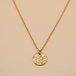 Hammered gold round pendant necklace on dainty gold chain