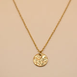 Hammered gold round pendant necklace on dainty gold chain
