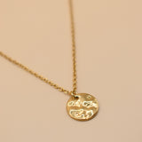 Hammered gold round pendant necklace on dainty gold chain