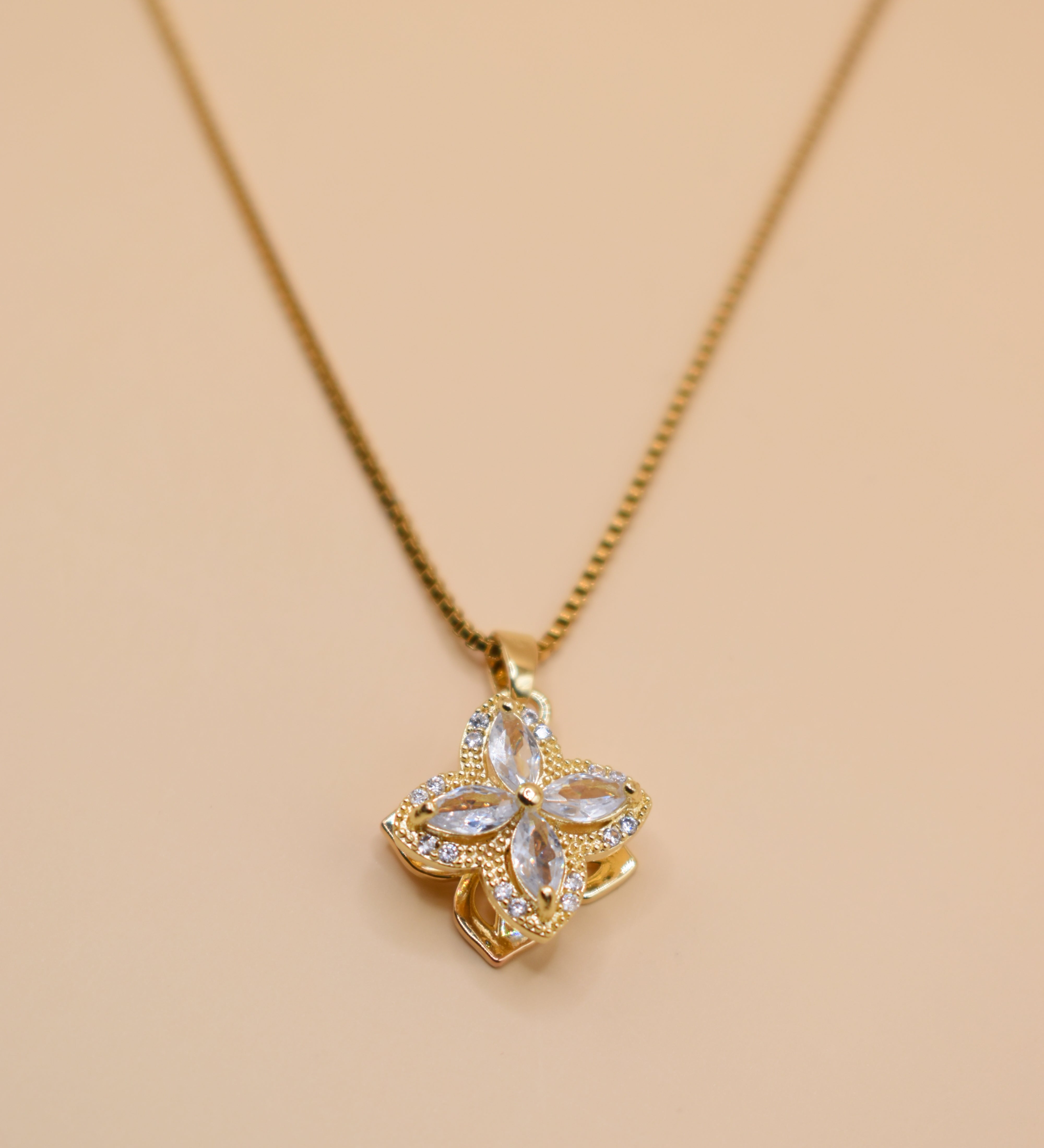 Gold clover pendant necklace with rotating charm