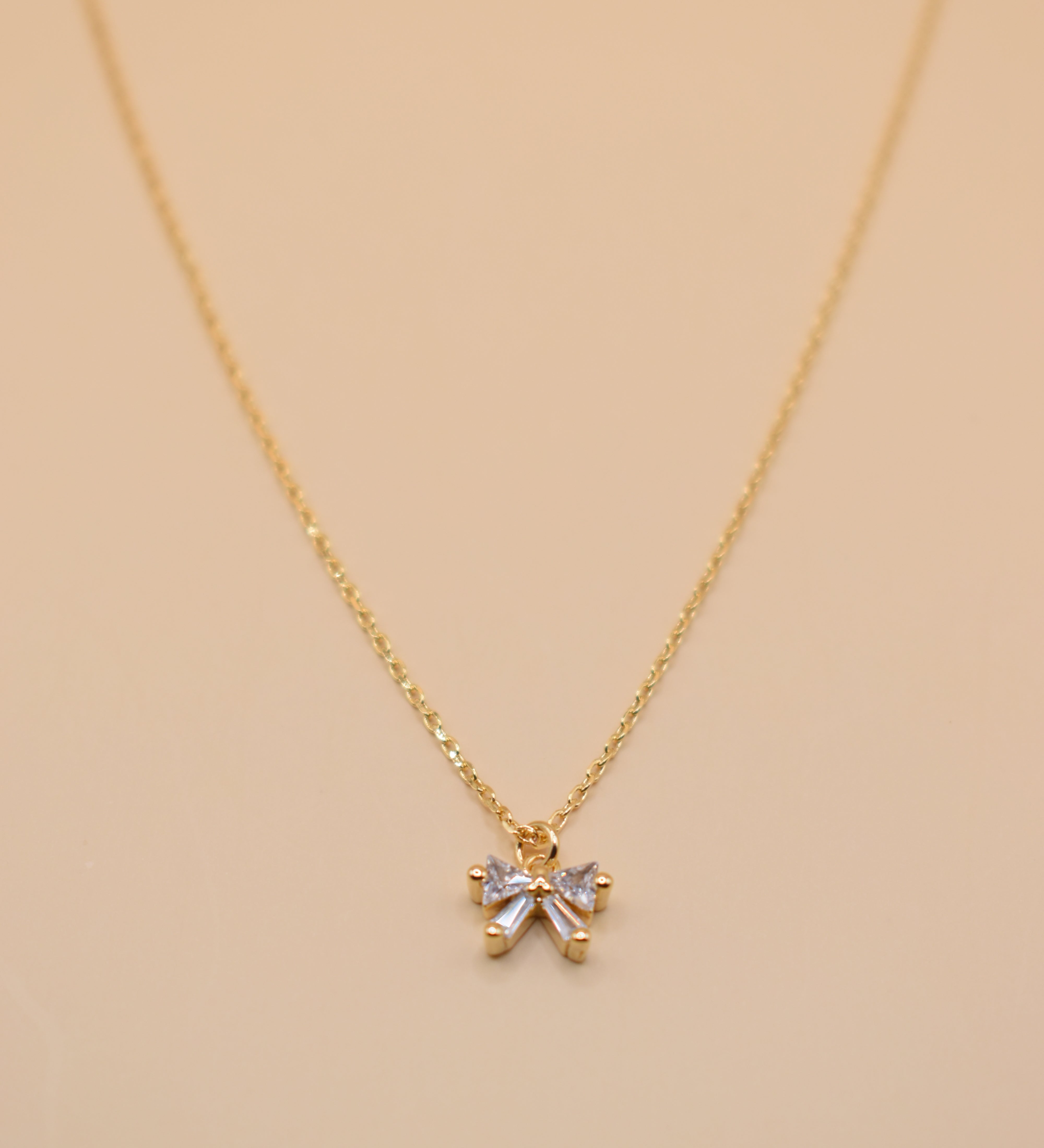 CZ bow pendant necklace on gold chain with dainty finish
