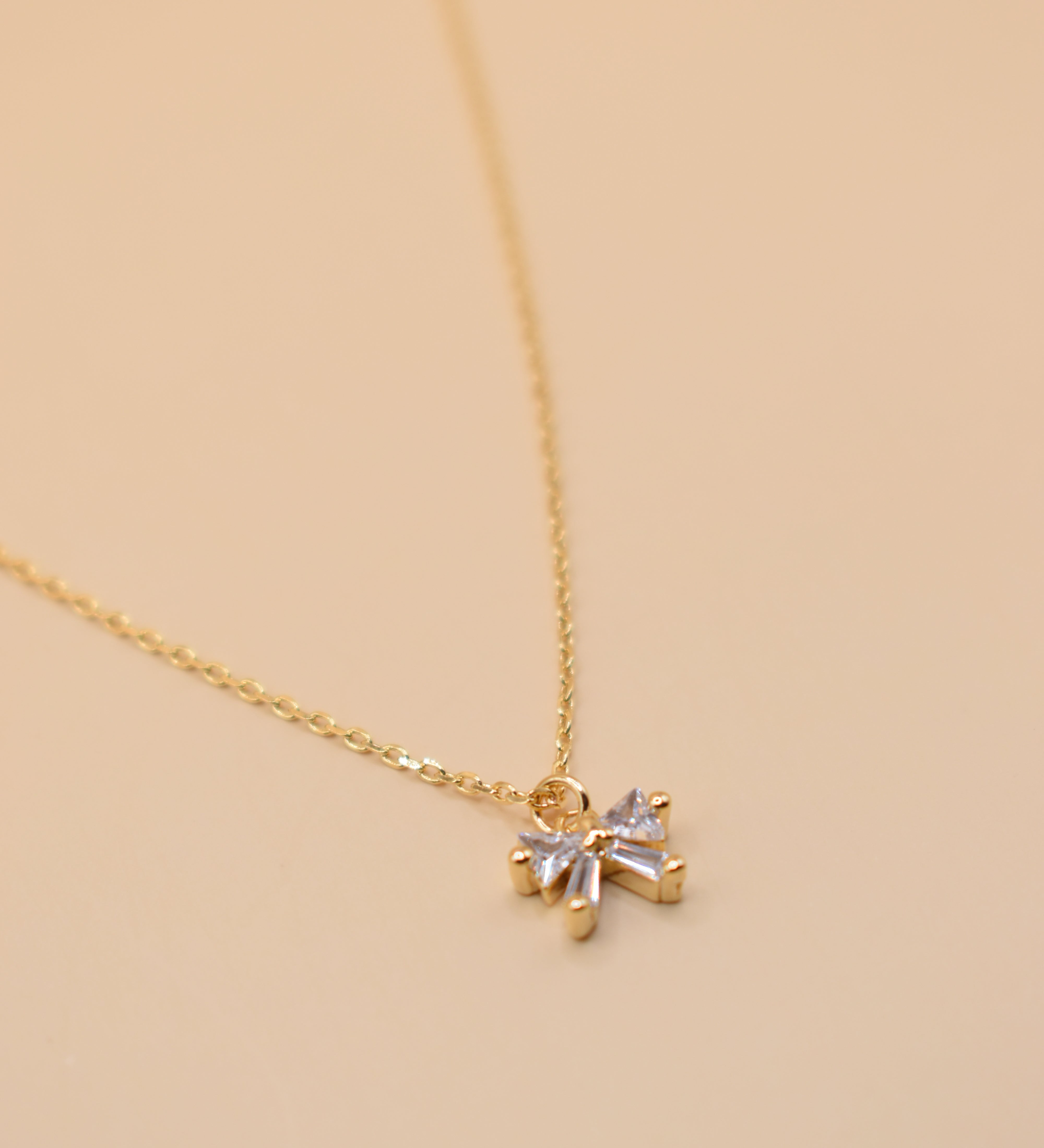 CZ bow pendant necklace on gold chain with dainty finish